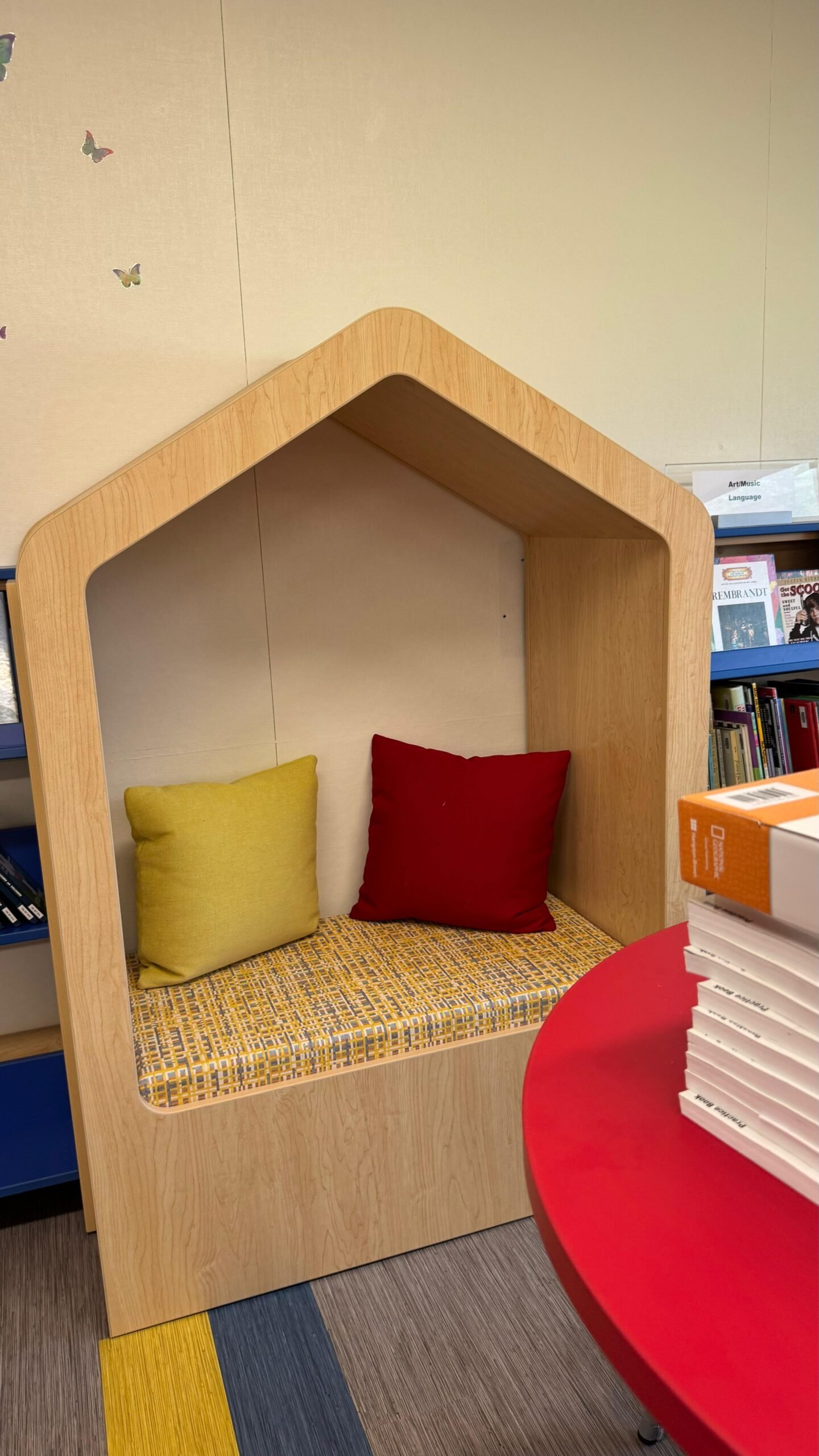 Wood school library reading nook with colorful cushions
