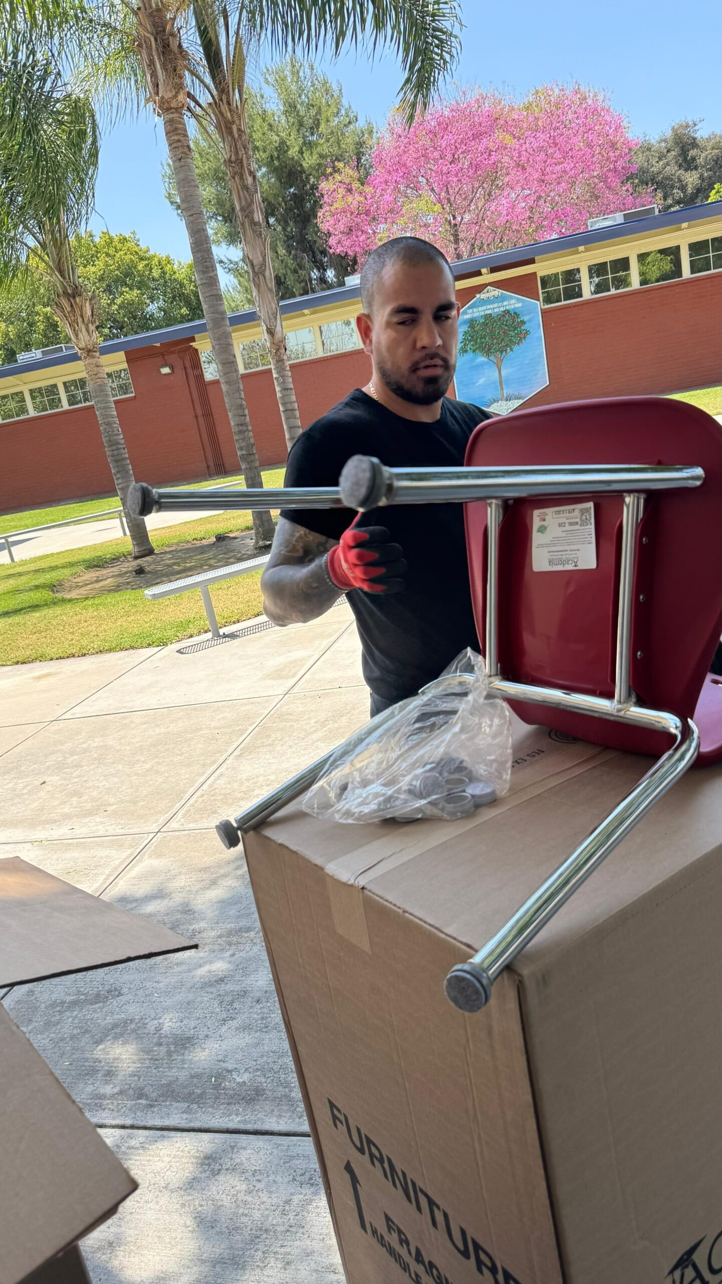 School furniture installer unpacking and preparing a student chair