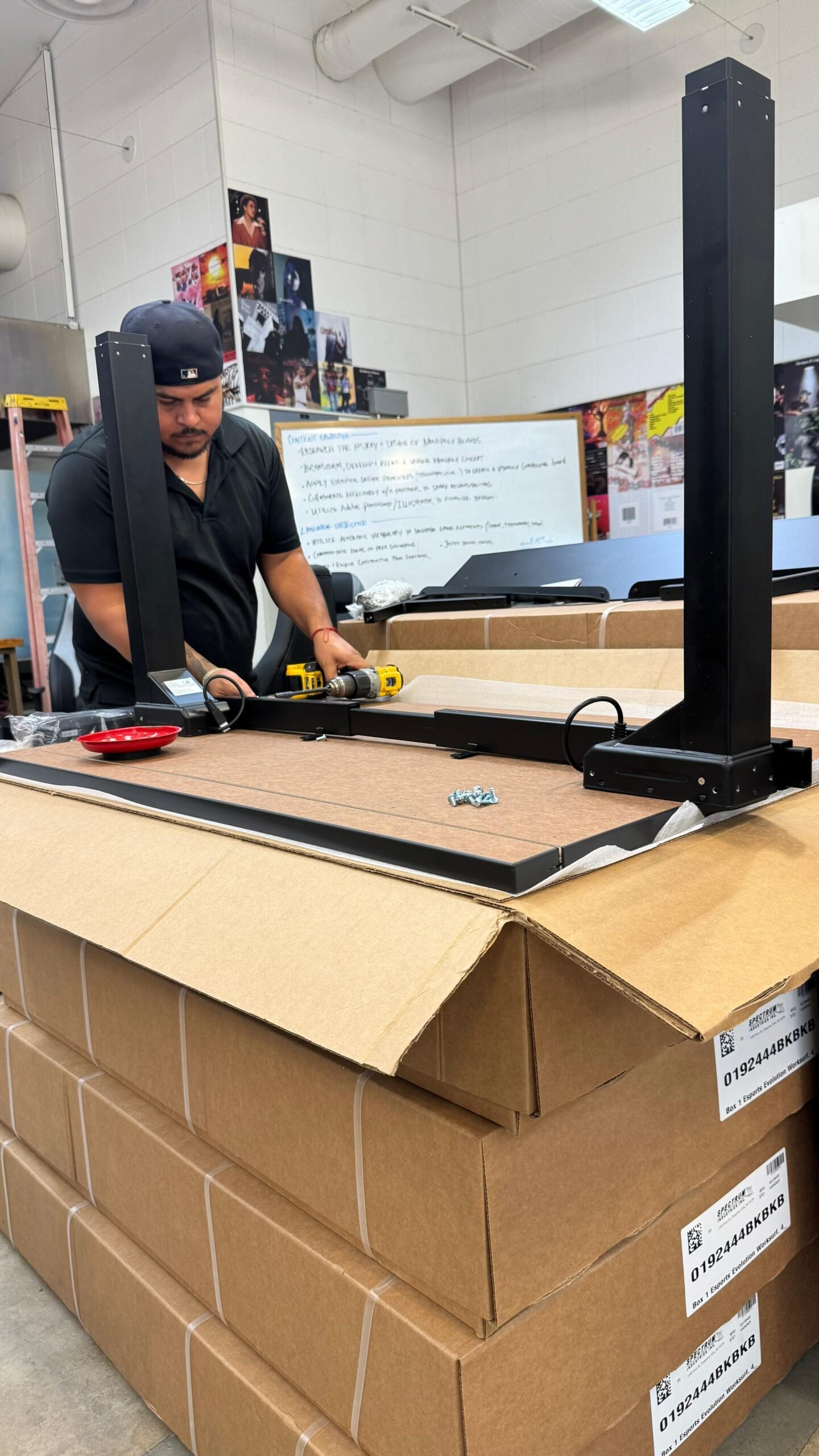 Installer assembling a large commercial table inside a school classroom