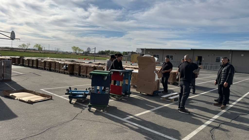 Commercial furniture components staged with moving equipment