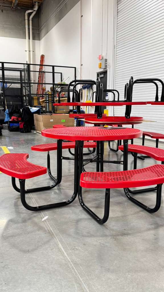 Completed red outdoor cafeteria tables for a school campus