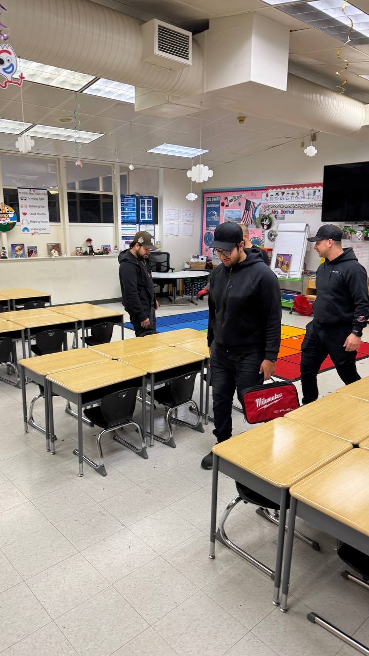 School furniture installation crew reviewing classroom desk placement