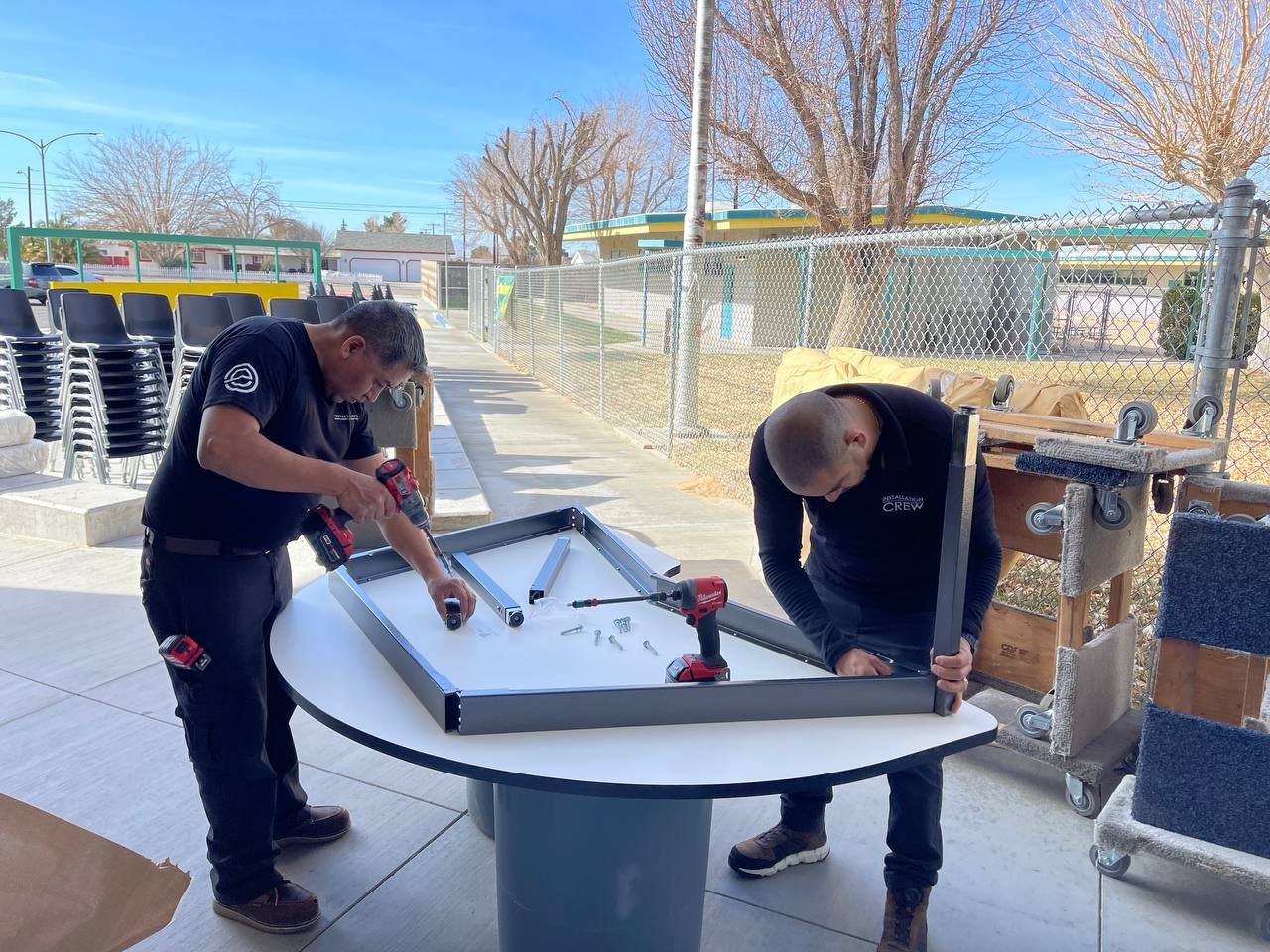 Installers assembling a commercial school table