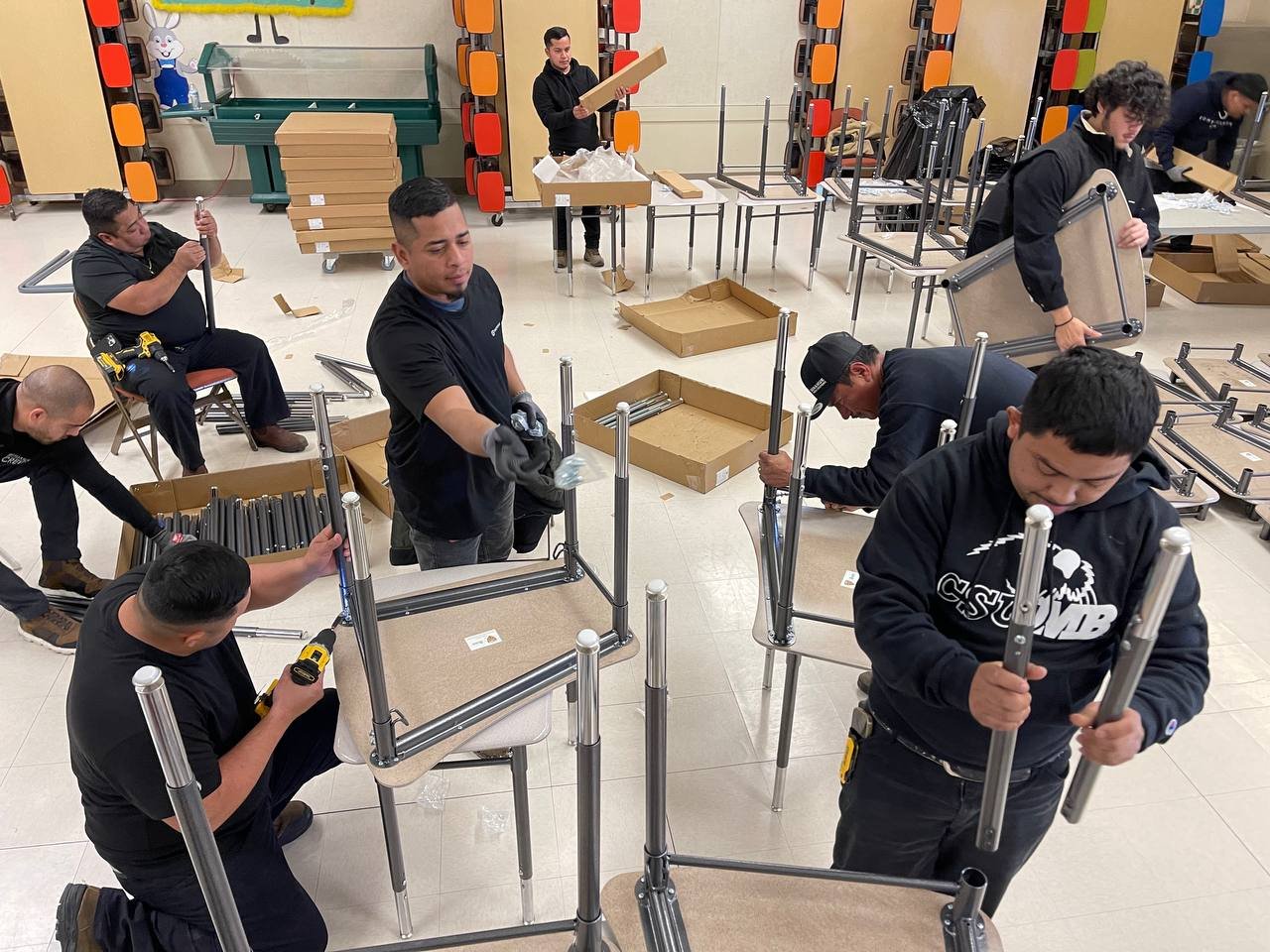 Large school installation team assembling classroom furniture
