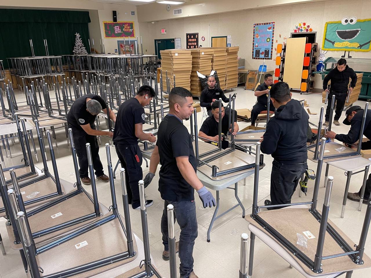 Commercial crew assembling a large quantity of school desks