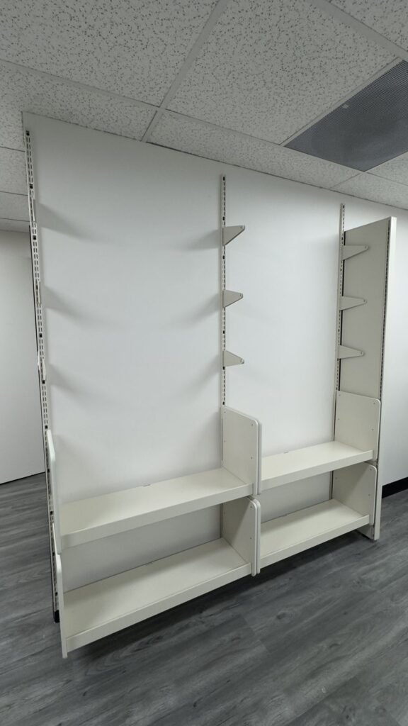 White modular office panels with adjustable shelf supports and lower storage shelves