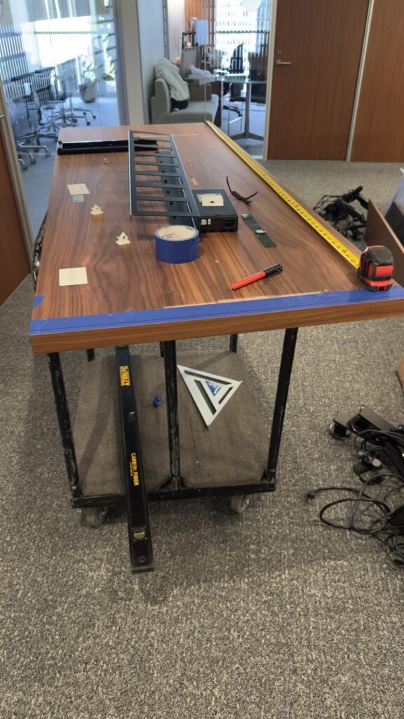 Commercial office work surface with measuring tools and components during installation preparation