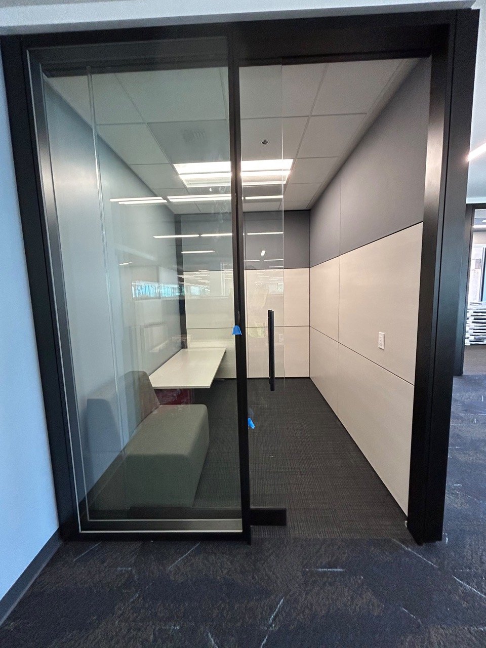 Black-framed office glass wall and door from an Elite Office Renovation project